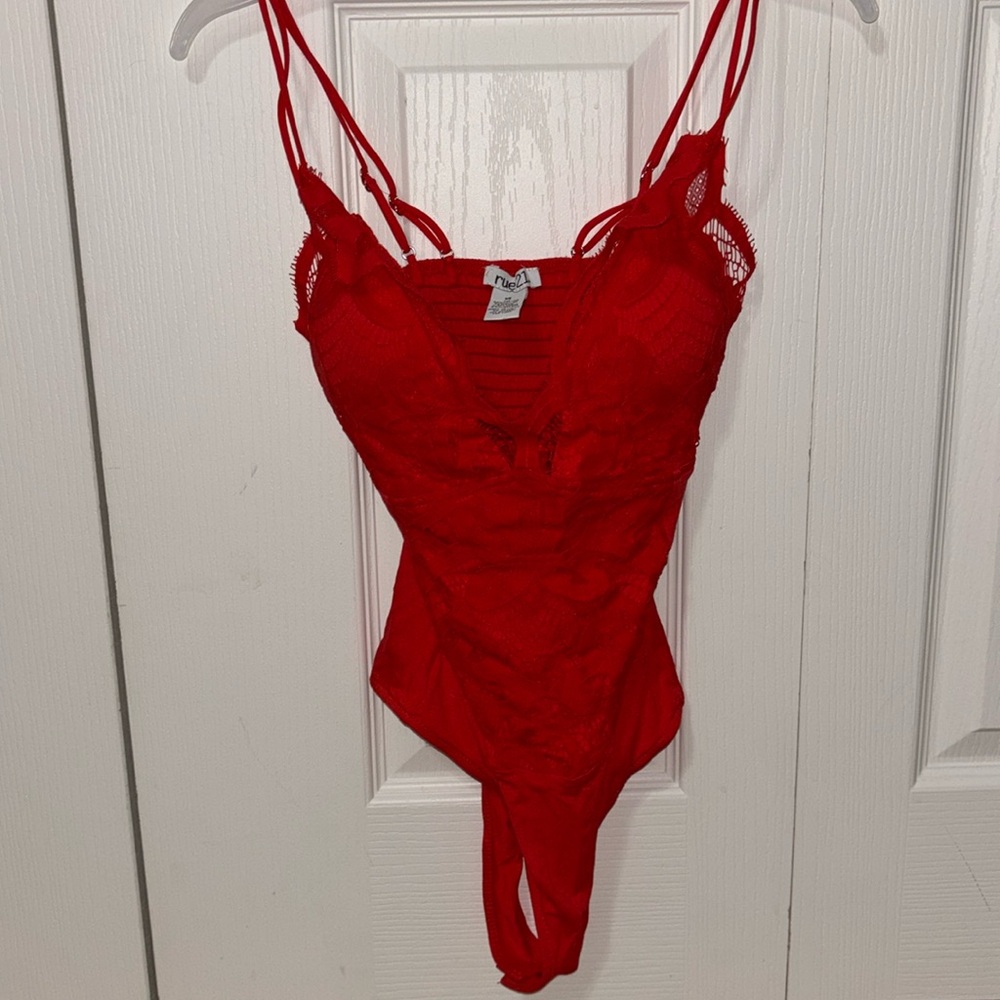 Red lace body suit. Size XS. Never worn, has cups for support in the chest area